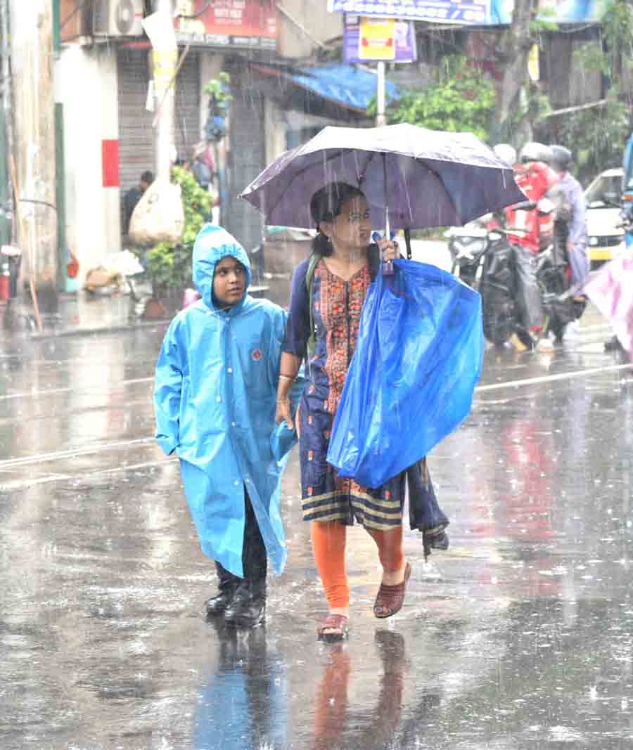 A student caught in the rain in north Kolkata on Tuesday. According to IMD, the recorded rainfall on Tuesday evening was 43.8mm