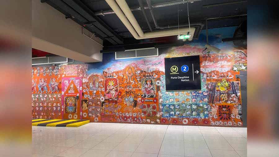 Inside a metro station in Paris, a mural wall with Indian deities