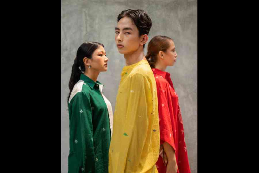 From slip-on kaftans to classy shirts, this frame explores festive street style in bright hues with an emphasis on comfort. (L-R) Classic white checks in handwoven sheer style merge with a dark green panel sprinkled with jamdani motifs in this shirt, redefining simplicity with an unusual classy touch; a boxy silhouette style comes in a cheerful yellow shade in this delicately handwoven sheer jamdani shirt, finished with minimal kantha embroidery on the sleeves and shoulders; and what better than enjoying pandal-hopping in a flowy red jamdani kaftan shirt dress, designed with a structured shirt collar and comfy handwoven khadi lining?