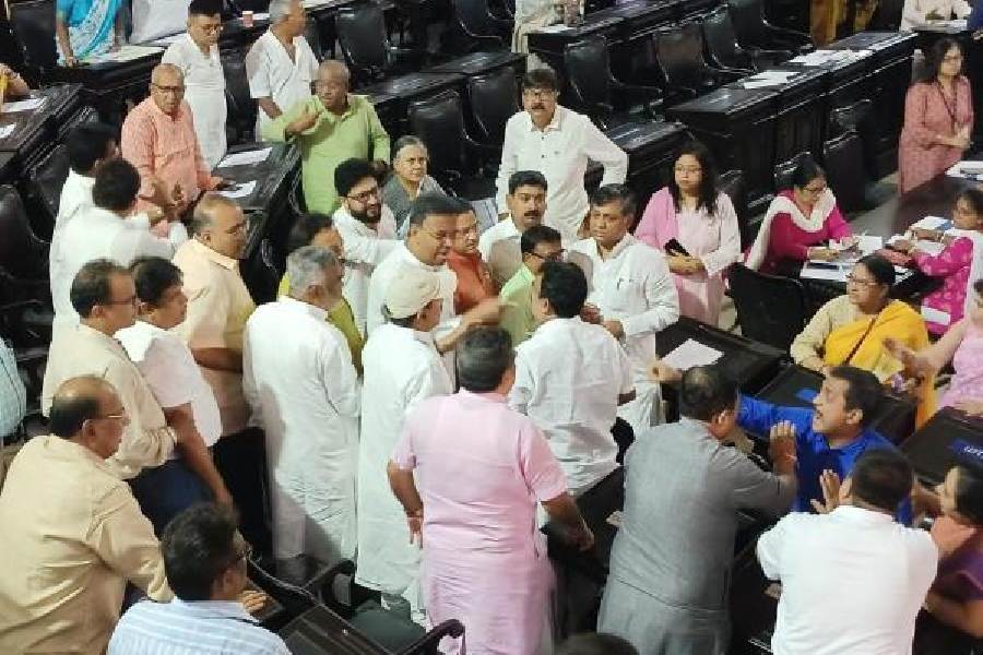 Mayor Hakim tries to separate the councillors involved in the scuffle in the council house of the Kolkata Municipal Corporation  on Saturday