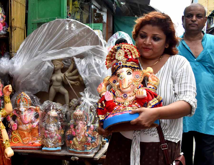 Ganesh makes its way to a devotee’s home even as an incomplete idol of his mother, Durga, is seen in the foreground. Durga Puja starts in 32 days