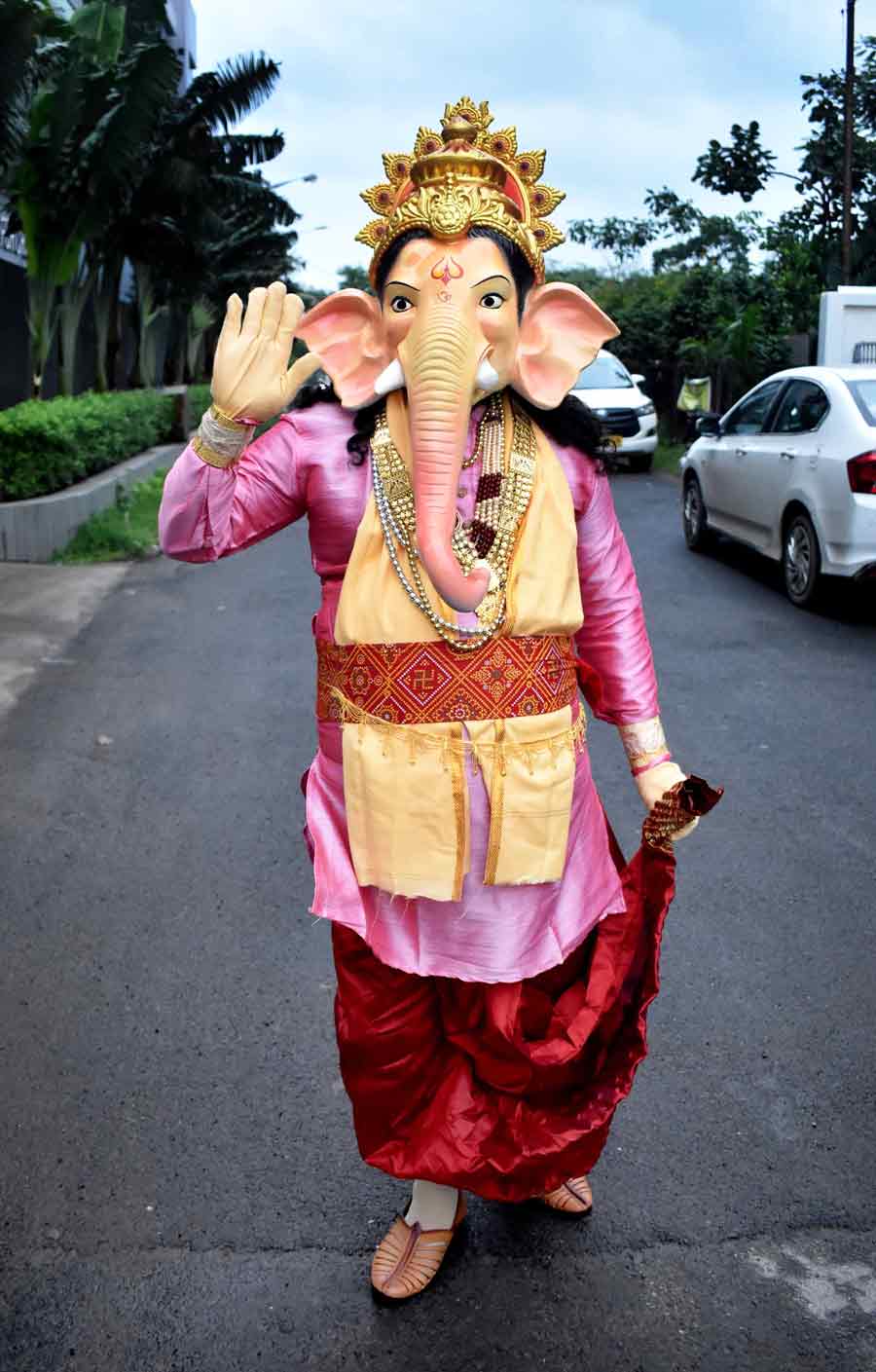 A living Ganesh turns a Bengali ‘babu’ on a Kolkata street replete with a pink kurta, maroon dhoti and Kolhapuri mojris on Monday 
