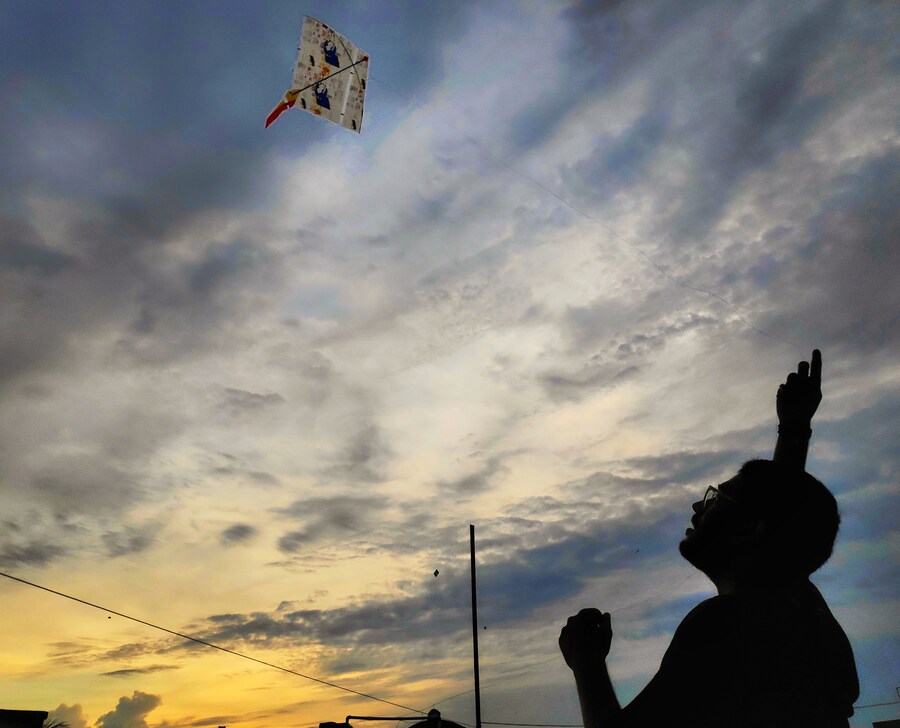 A man flying kite on the ocassion of Vishwakarma Puja. It is an old tradition to fly kites on this day