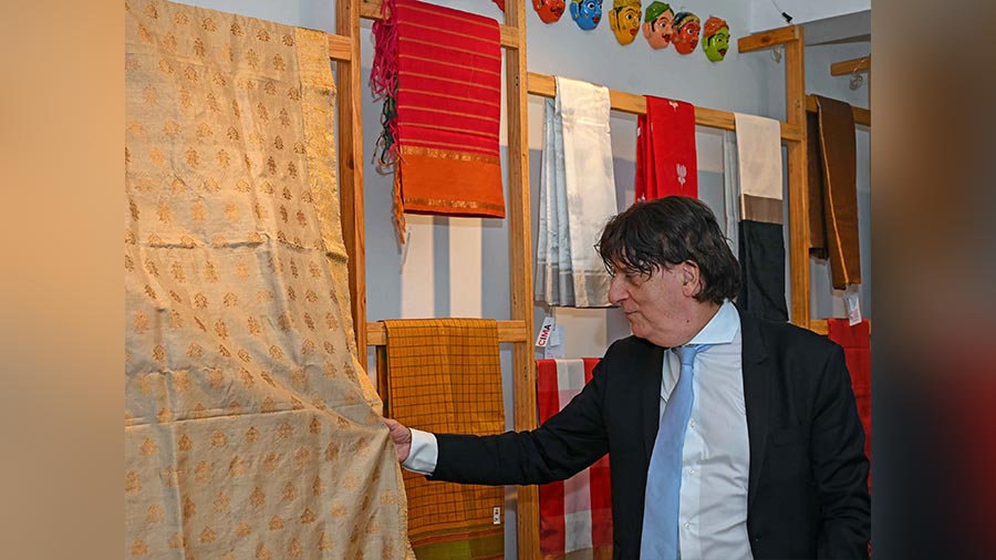 Didier Talpain, consul-general of France in Kolkata, admires the soft hues of a sari designed by Sampa Das