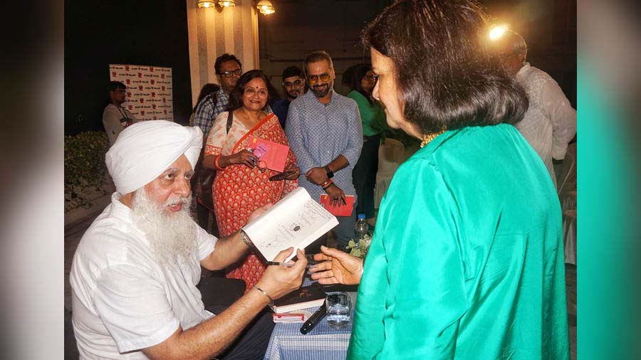 Singh signs copies of his book