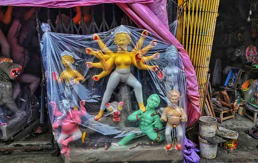 The frequent spells of rain have forced Kumartuli artists to work “under cover” to finish their assignments before the Durga Puja deadlines 