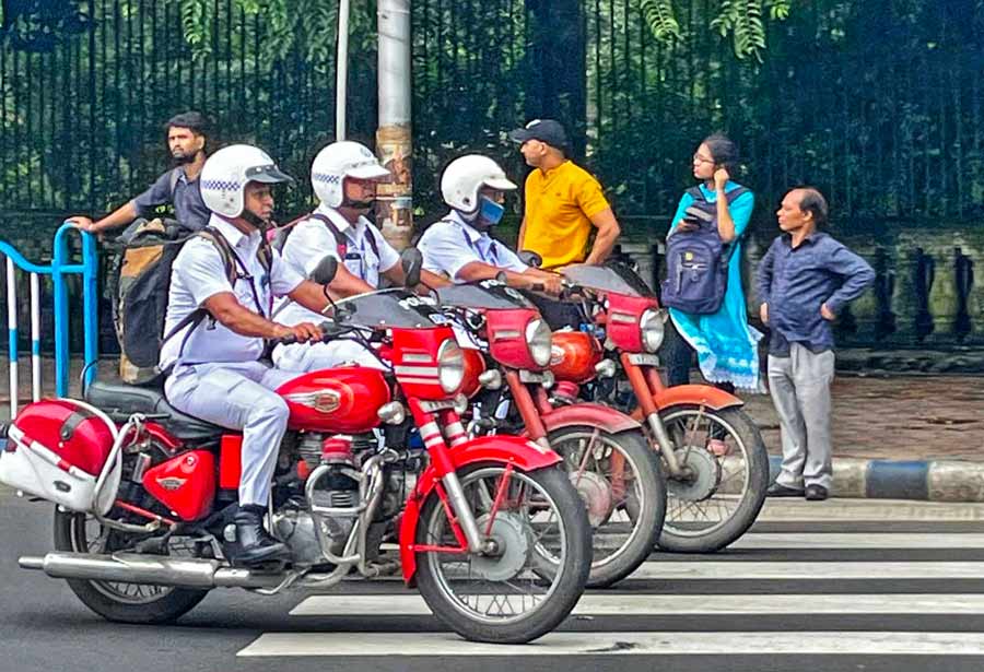  Three Kolkata Traffic Police sergeants ride in sync with one another on Marx Engels Beethi Sarani on Saturday