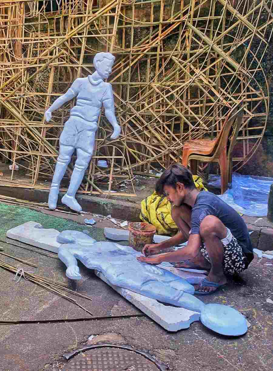 Workers at Dom Para working in full swing to make props for various Durga Puja pandals 