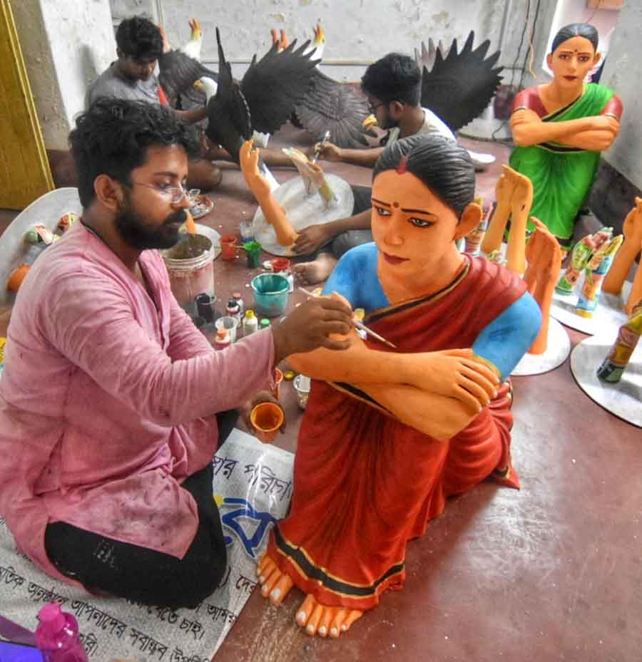 The theme of Shyambazar Pally's Durga Puja is surrogacy this year. Workers were seen giving finishing touches to figurines on Wednesday   