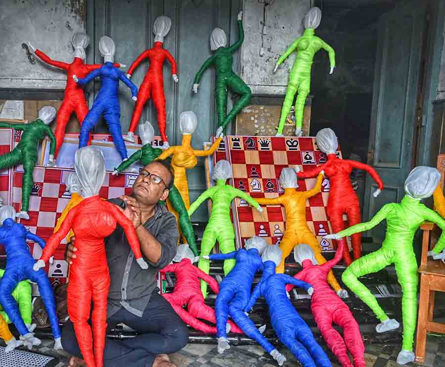 An artisan works on puppets for the Kumartuli Park Sarbojanin Durgotsav pandal on Wednesday 