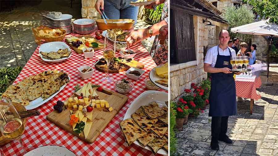 A Croatian table including the traditional soparnik and (right) a waiter holding glasses of Croatian wine