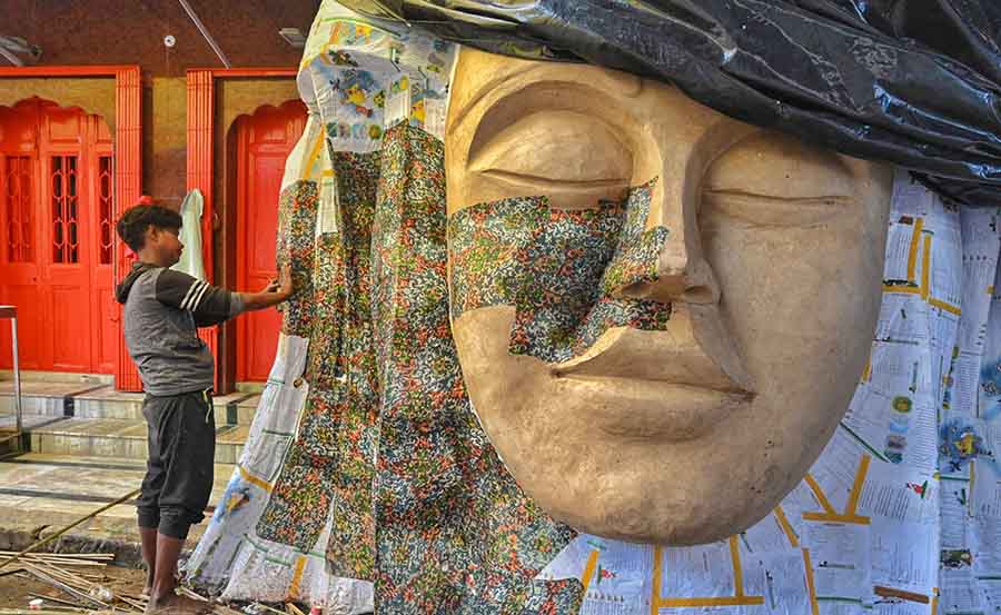 An artisan races against time to complete props at Dompara for different Durga Puja pandals