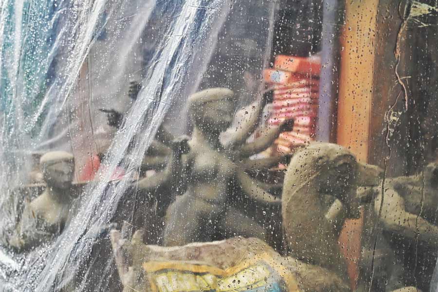 With barely three weeks for Durga Puja to start, a transparent polythene protects the goddess from rain in Kumartuli on Saturday 
