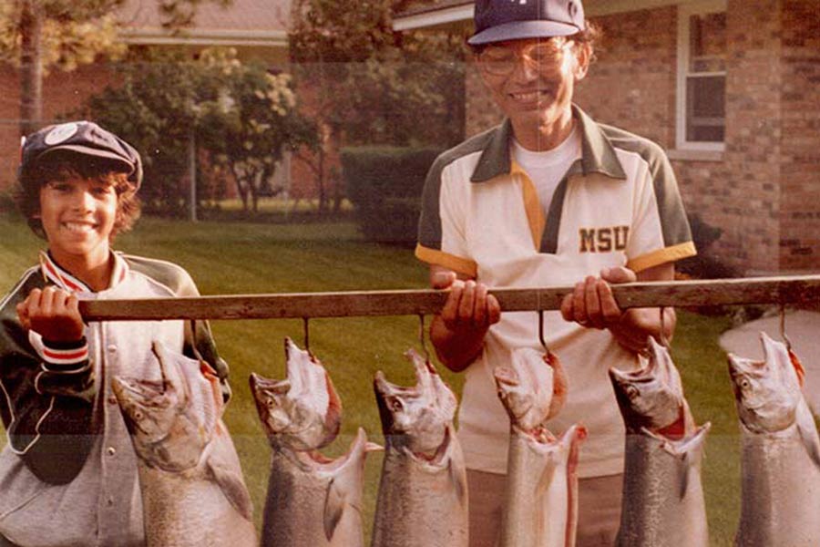 A 13-year-old Janam fishing with his father in Michigan