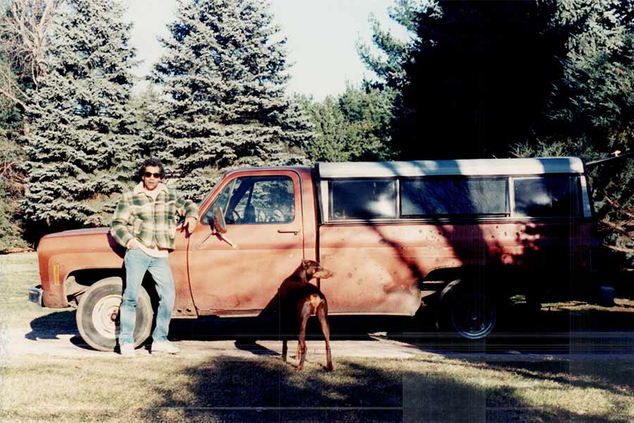 Janam and his dog Drake in Alaska, in front of a truck the author lived in for a year and a half while travelling during 1993-94 