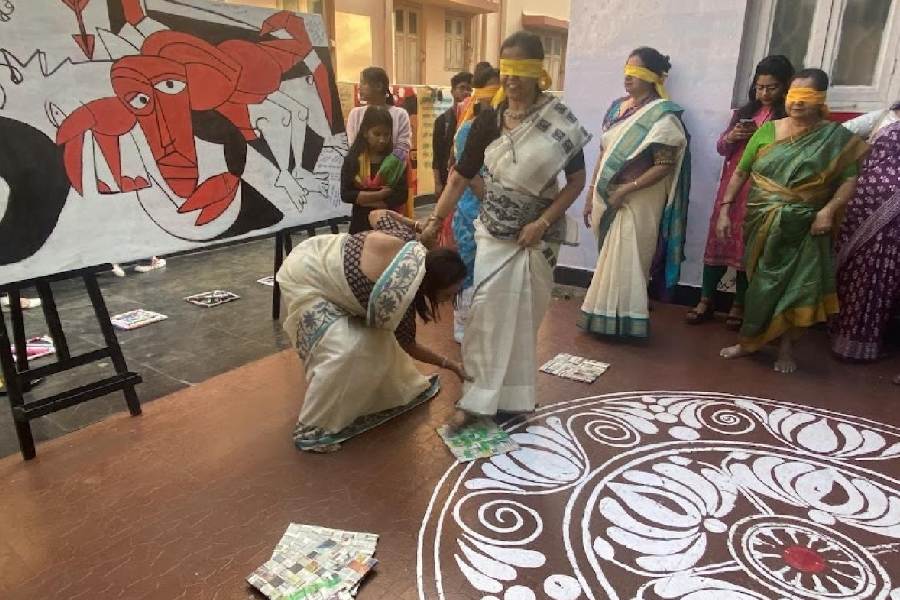 Leader Gayatri Biswas guides the step of a blindfolded team member as part of a lifeskill game at Prayasam in CG Block on Women's Day  at 