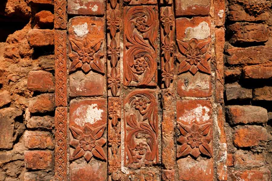  Floral pattern terracotta panels adorn the wall of one of the three south-facing temples