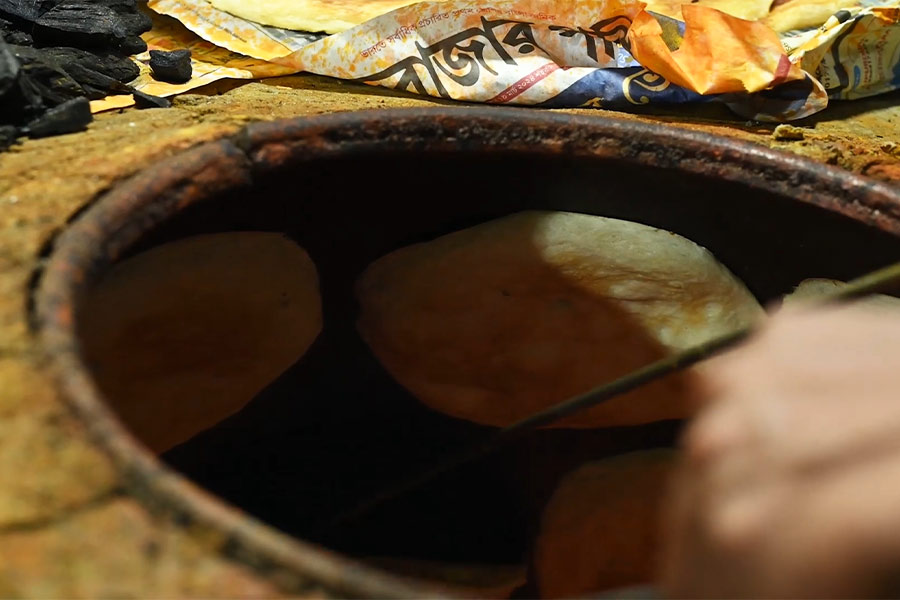 The naan is made in a traditional clay tandoor