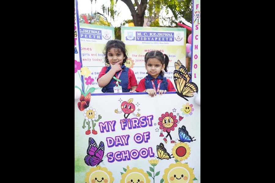 Two girls have fun on their first day in school as MCKV turns co-educational.