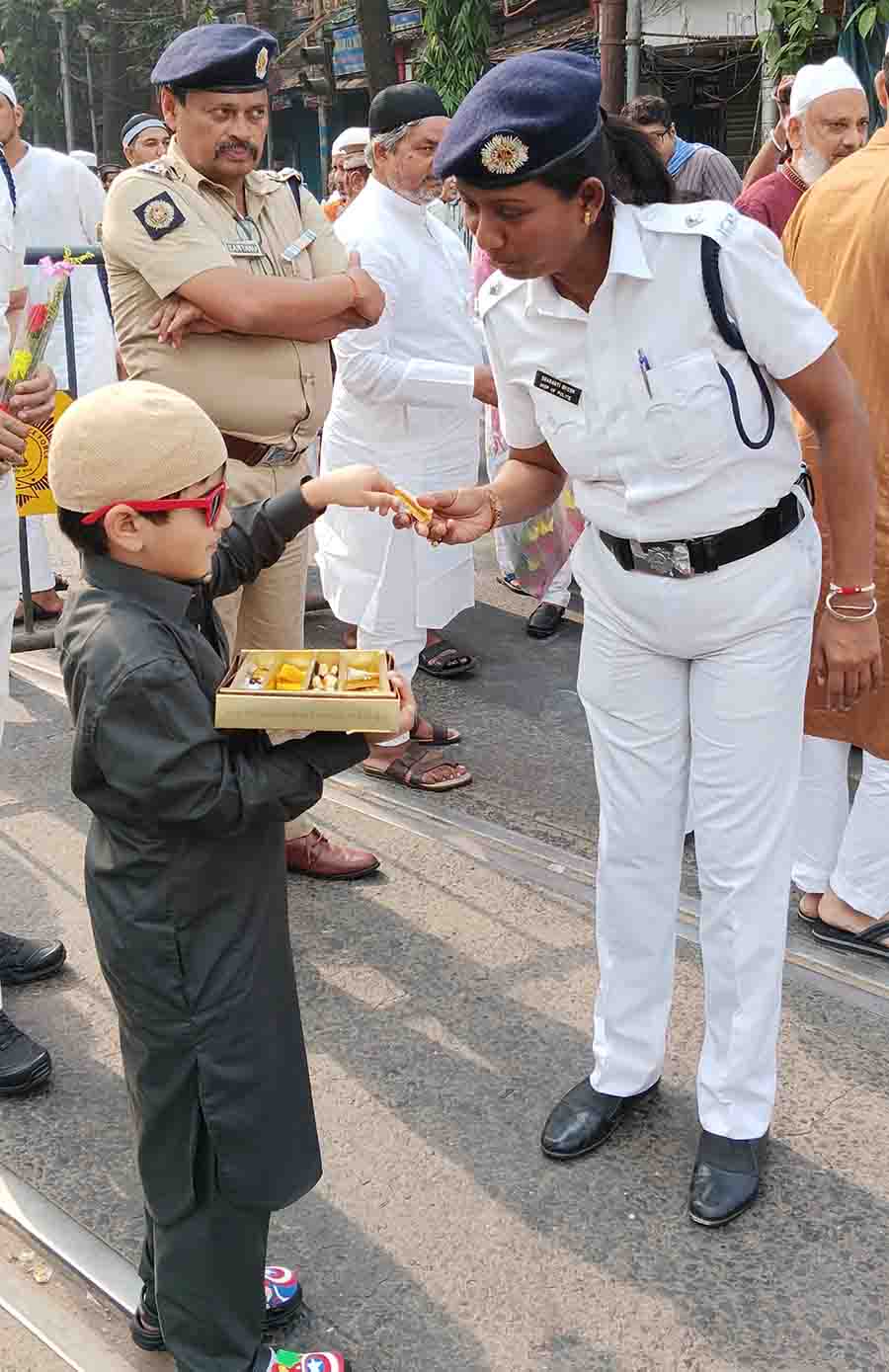 This young man was spotted distributing sweets to a policewoman at Esplanade after the prayers