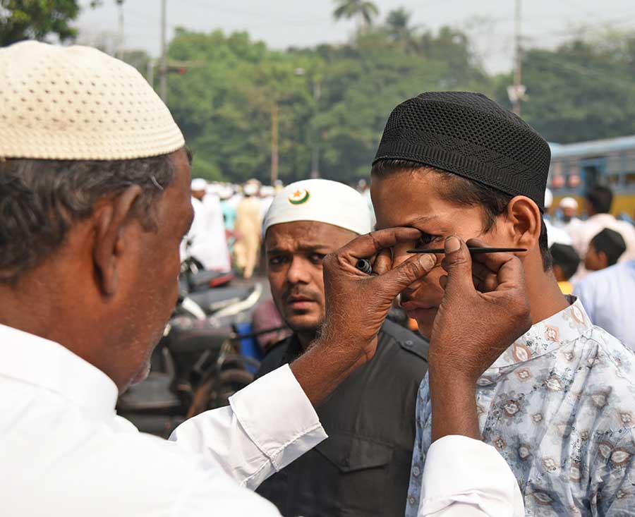 A teenager gets ‘surma’ applied to his eyes before attending Eid prayers at Red Road 