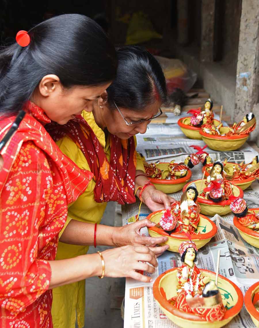 Women choose idols for Gangaur Puja, a festival celebrated by the people of Rajasthan, at Kumartuli  
