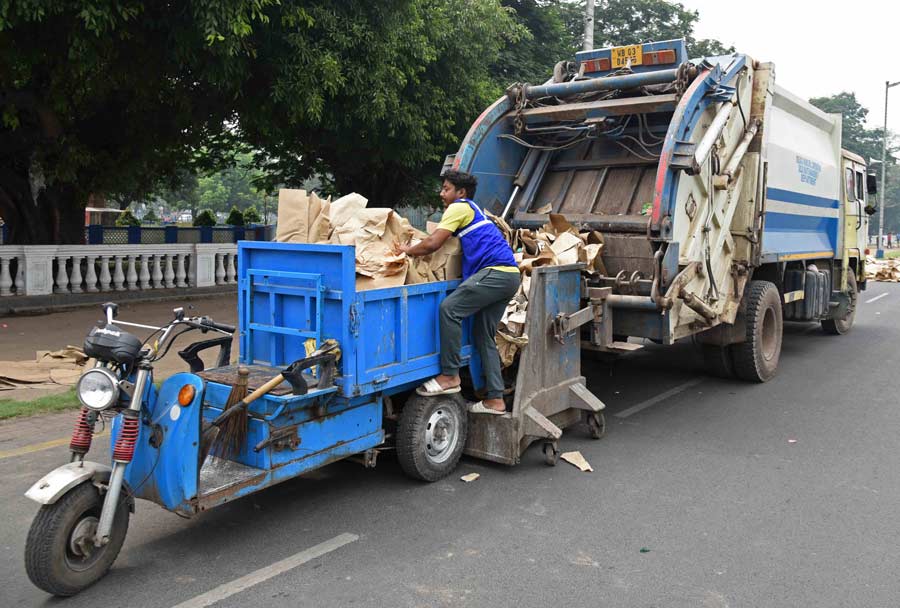 Kolkata Municipal Corporation (KMC) workers on a clean-up drive around Red Road on Thursday  