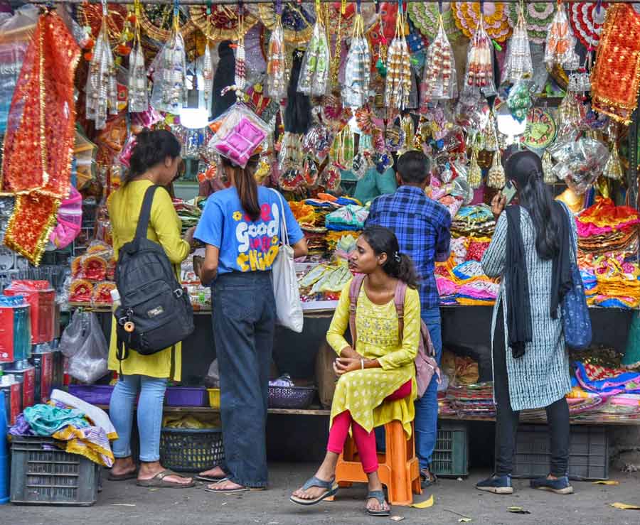 Shoppers at Hatibagan at a stall selling clothes for deities ahead of Poila Baisakh   