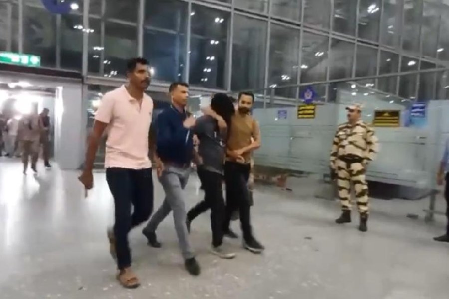 One of the arrested duo at the Kolkata airport on Friday evening. The two were flown to Bengaluru.
