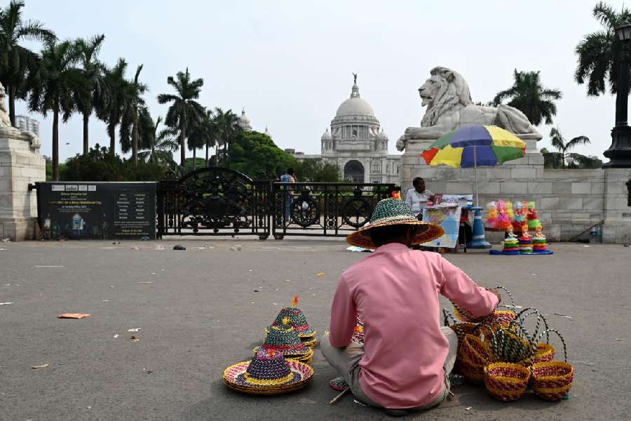 A hat seller waits for customers in front of the Victoria Memorial on Friday afternoon.