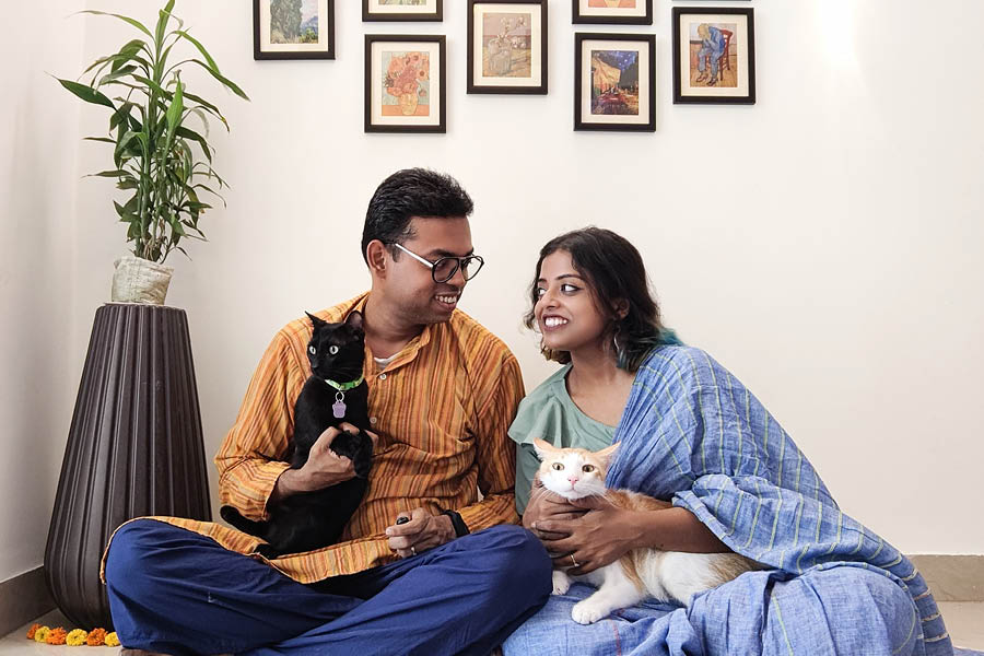 Rupsha and her partner with their cats, Champagne, and T'Challa