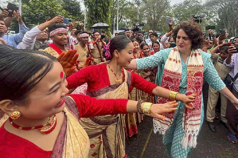 Priyanka Gandhi Vadra dances with artists during an election campaign rally in Assam’s Jorhat district on Tuesday.