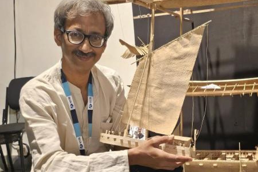 Swarup Bhattacharyya holds one of his creations, a Khoro Kisti, at the exhibition held behind City Centre