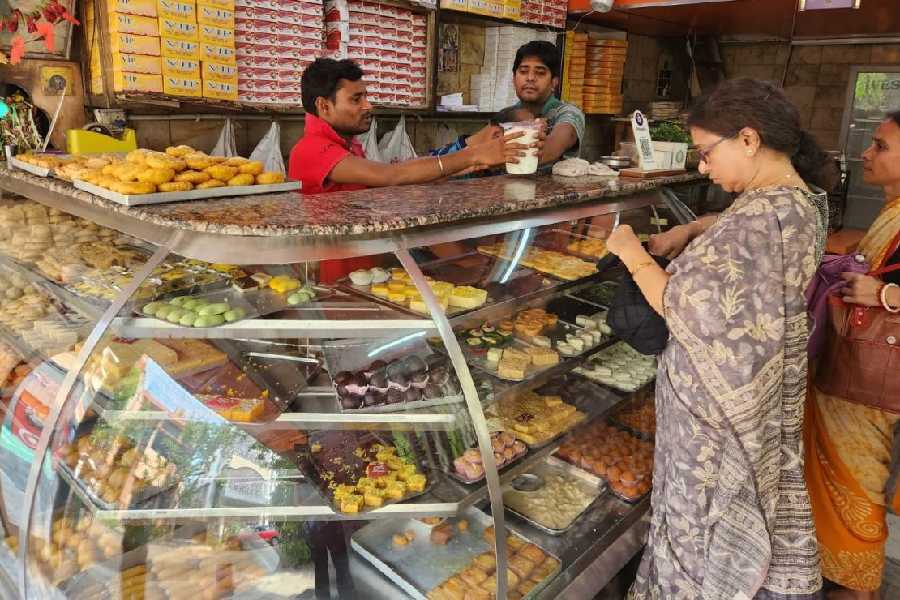 A lady makes a purchase at VIP Sweets in DL Block.