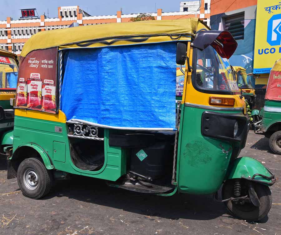 A polythene sheet rolled down in an autorickshaw outside Sealdah station to protect passengers from the afternoon sun