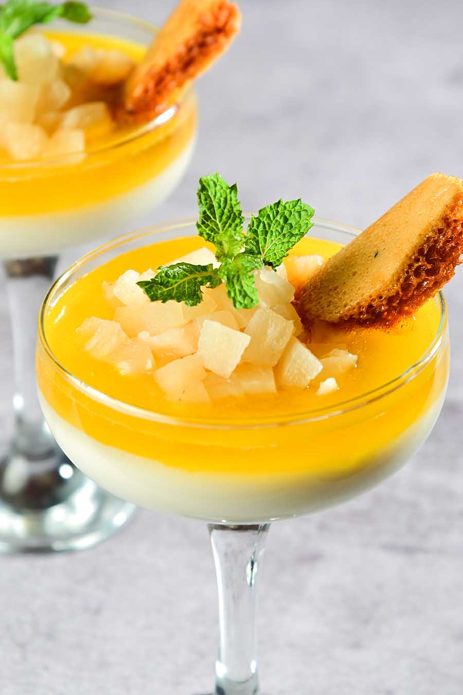 Classic tropical flavours of coconut and pineapple come together in a delightful summer-perfect concoction. The layered Coconut Pineapple Panna Cotta features velvety white chocolate and coconut panna cotta, and the fresh flavours of a pineapple jelly, all dressed with a special honeycomb biscotti