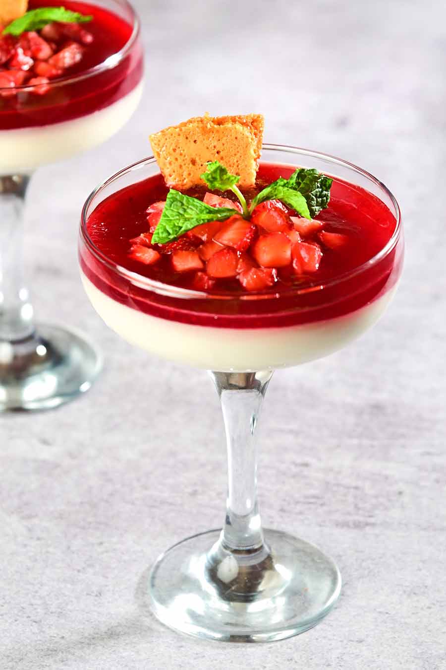 The Strawberry Panna Cotta features a smooth vanilla-infused panna cotta with a layer of vibrant strawberry compote and topped with fresh slices of strawberries. The sweet and rich panna cotta mixed with the slight tart flavours of the strawberry create an appealing combination