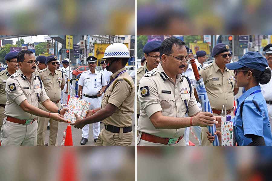 Police commissioner Vineet Kumar Goyal distributes summer essentials such as umbrellas at Park Circus seven-point crossing on Monday morning