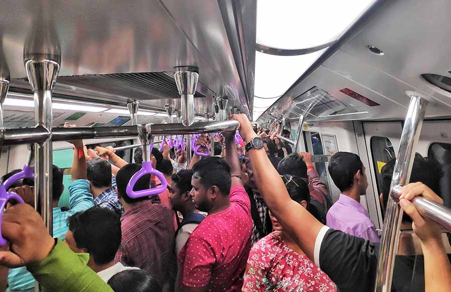 A fairly crowded AC Metro compartment on its way from Howrah Maidan to the central business district