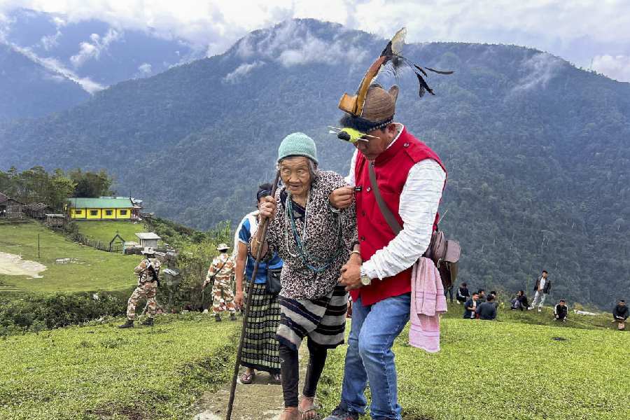 An elderly voter being escorted during the first phase of Lok Sabha elections, in Kurung Kumey district, Arunachal Pradesh, Friday, April 19, 2024