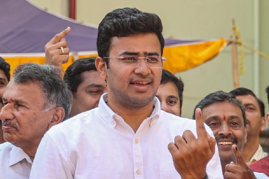 Bengaluru South constituency BJP candidate Tejasvi Surya shows his finger marked with indelible ink after casting his vote for the 2nd phase of Lok Sabha elections