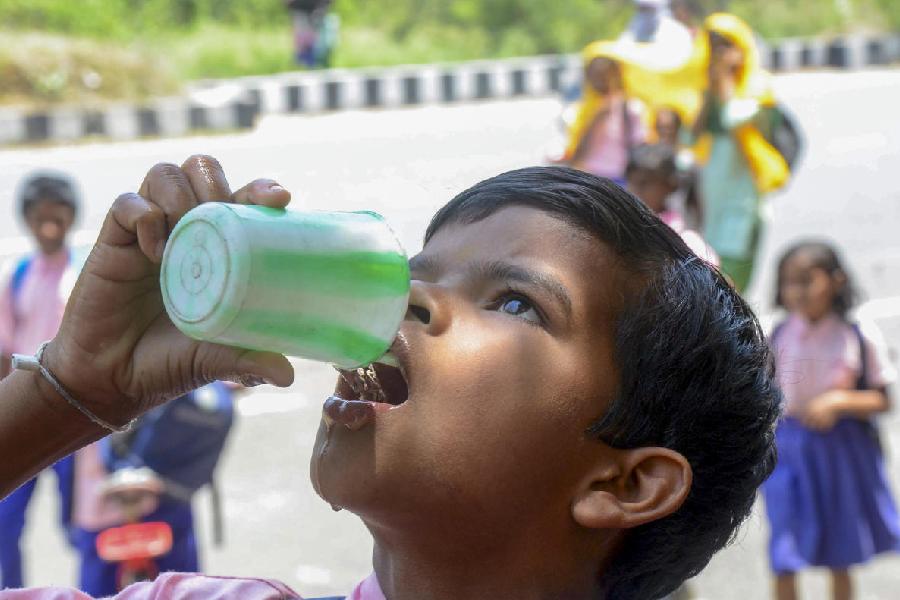 A student drinks water on a hot summer day, in Ranchi, Friday, April 26, 2024