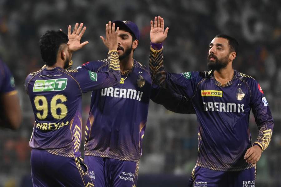 Varun Chakravarthy (right) celebrates after one of his three wickets on Monday.