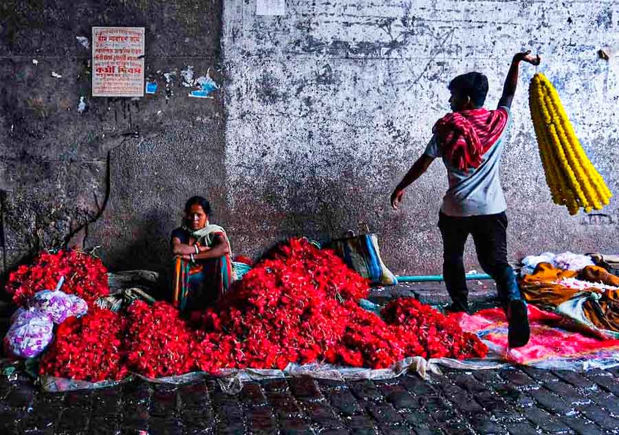 Florists sell marigold garlands and other flowers under the Brabourne Road flyover near Mullickghat on Thursday morning