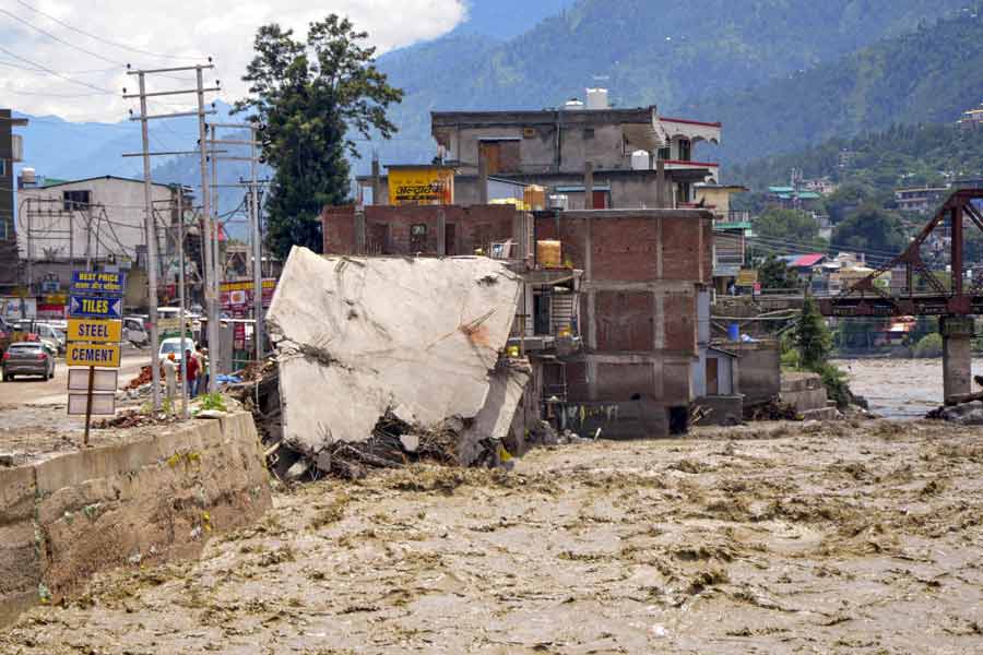 A damaged property is seen alongside a swollen Beas River, following a recent cloudburst, in Kullu district, Thursday, Aug. 1, 2024.