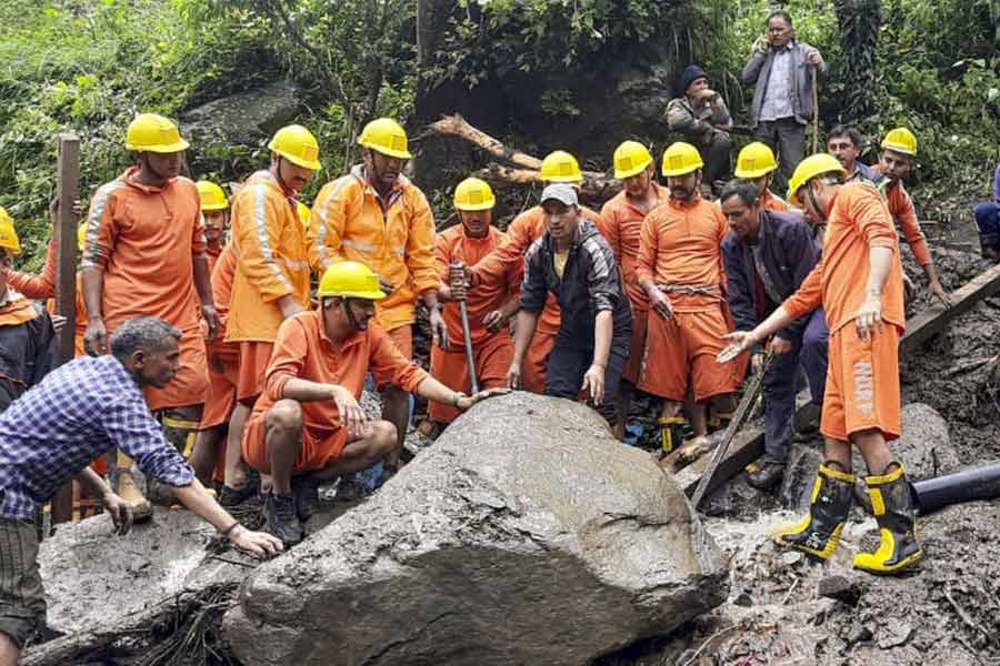 Rescue officials during a rescue operation at an affected area of Rajvan village following a cloudburst, in Mandi district, Thursday, Aug. 1, 2024.