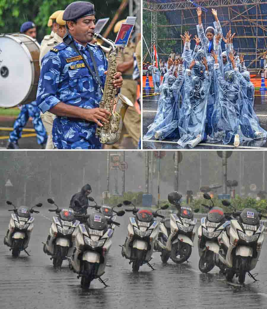 Participants for the Independence Day parade brave intermittent rain during rehearsal on Red Road on Saturday