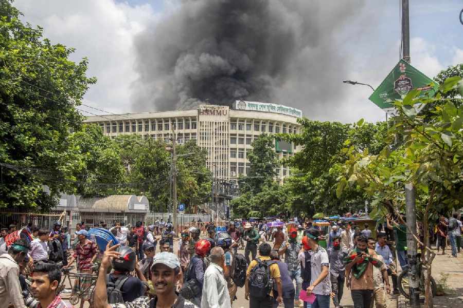 Black smoke rises from the Bangabandhu Sheikh Mujib Medical University (BSMMU) during clashes between protesters and Awami League members, on the first day of the non-cooperation movement at Dhaka University campus in Dhaka