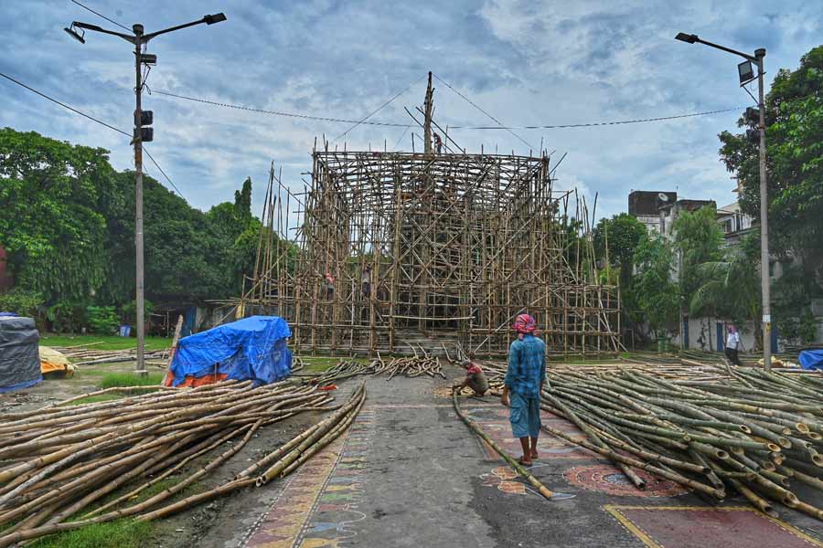 Labourers work on the Bagbazar Sarbojanin pandal for Durga Puja on Monday
