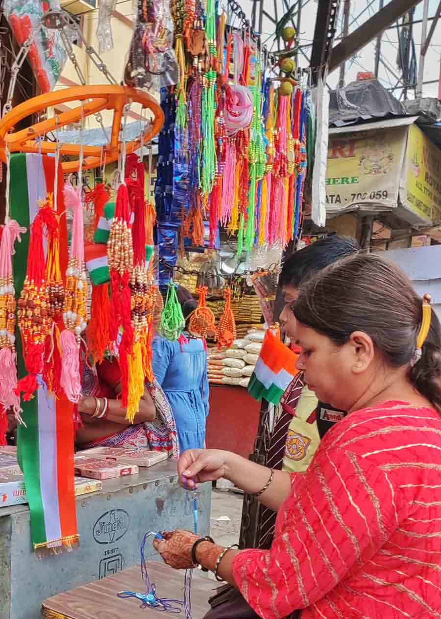 People buy rakhis and the Tricolour from a pavement stall in north Kolkata on Monday. August 15 is Independence Day, while Raksha Bandhan falls on August 19 this year